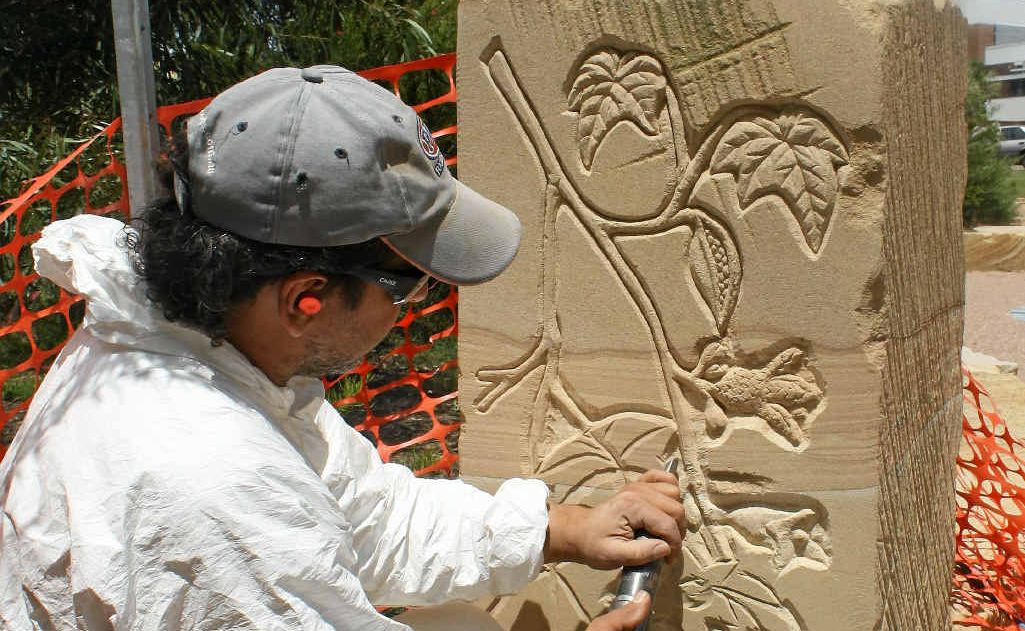 Local artist Paul Stumkat preparing the sandstone at the Peace Garden.